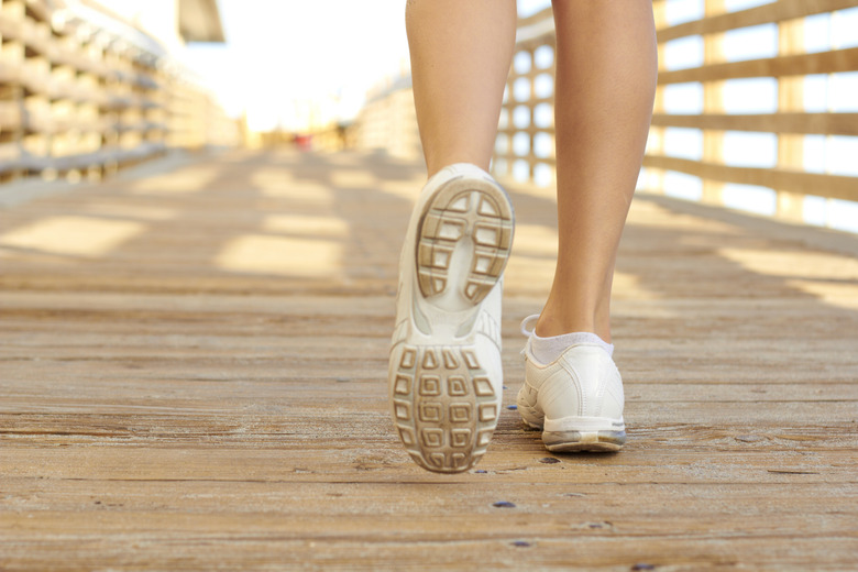 Close up of white sneakers walking the boardwalk